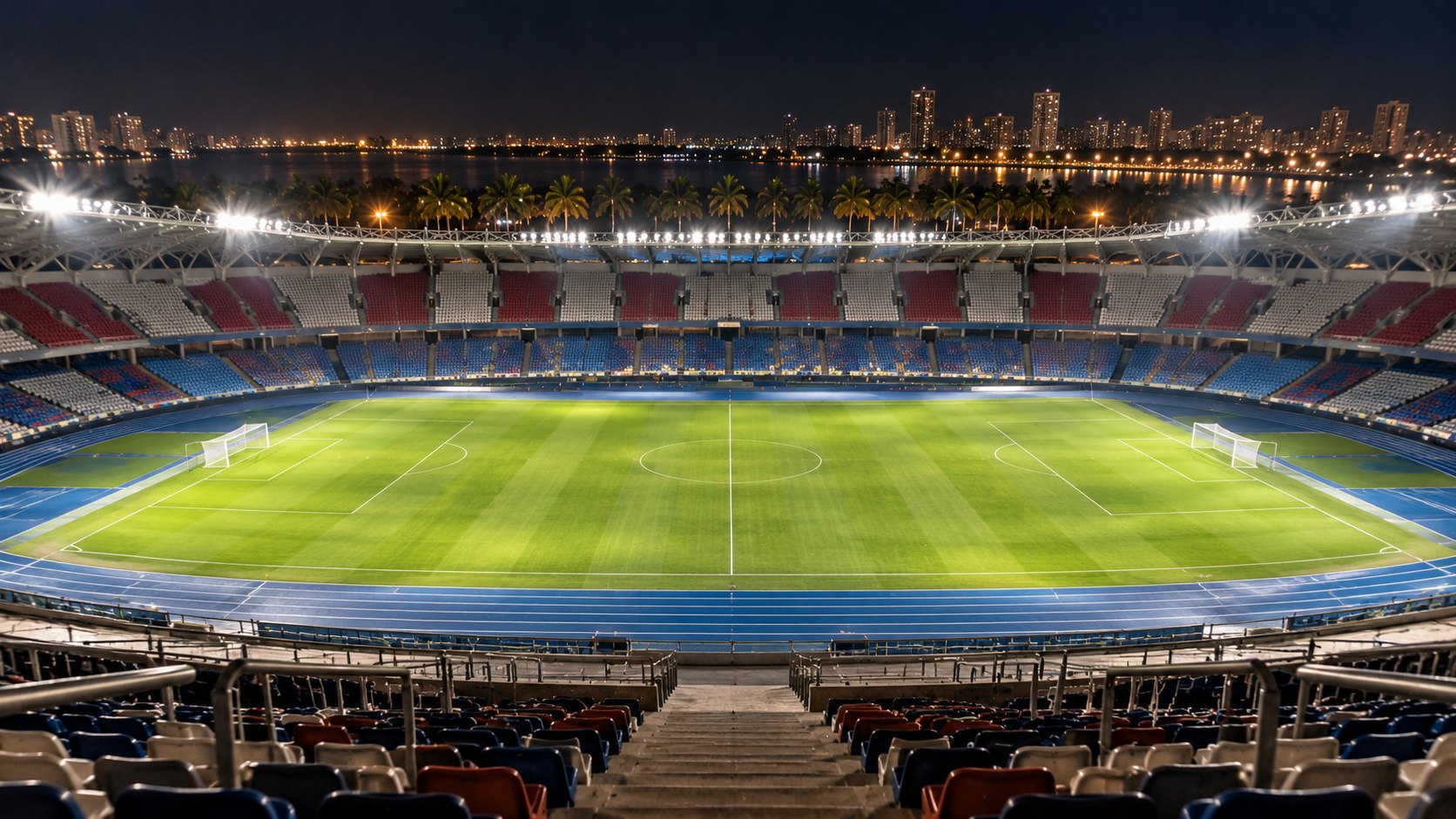 Ilustración editorial generada con IA: un estadio de fútbol vacío e iluminado de noche junto a una ciudad costera con palmeras, en referencia a la final única de Barranquilla; composición conceptual, no es una fotografía del estadio Metropolitano Roberto Meléndez.